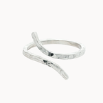 silver hammered ring with unique open shape on a white background