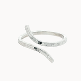 silver hammered ring with unique open shape on a white background