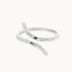 silver hammered ring with unique open shape on a white background