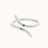 silver hammered ring with unique open shape on a white background