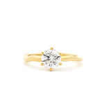round solitaire diamond engagement ring with 6 round prongs, with wavy molten yellow gold band against a white background