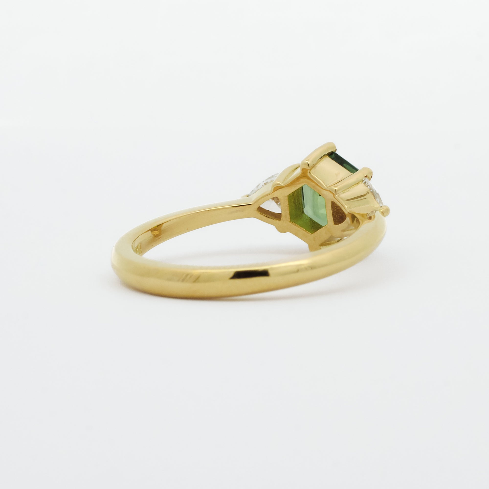 back view of hexgaon sapphire engagement ring with low setting on white background