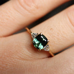 cushion cut green sapphire engagement ring on hand