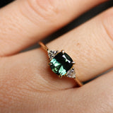 cushion cut green sapphire engagement ring on hand