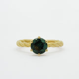blue/green sapphire engagement ring with gold twisted shank on white background