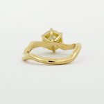 back view of engagement ring with wavy design on a white background