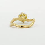 back view of engagement ring with wavy design on a white background