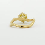 back view of engagement ring with wavy design on a white background