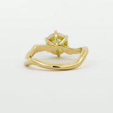 back view of engagement ring with wavy design on a white background