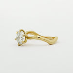Gold ring with a diamond on a white background