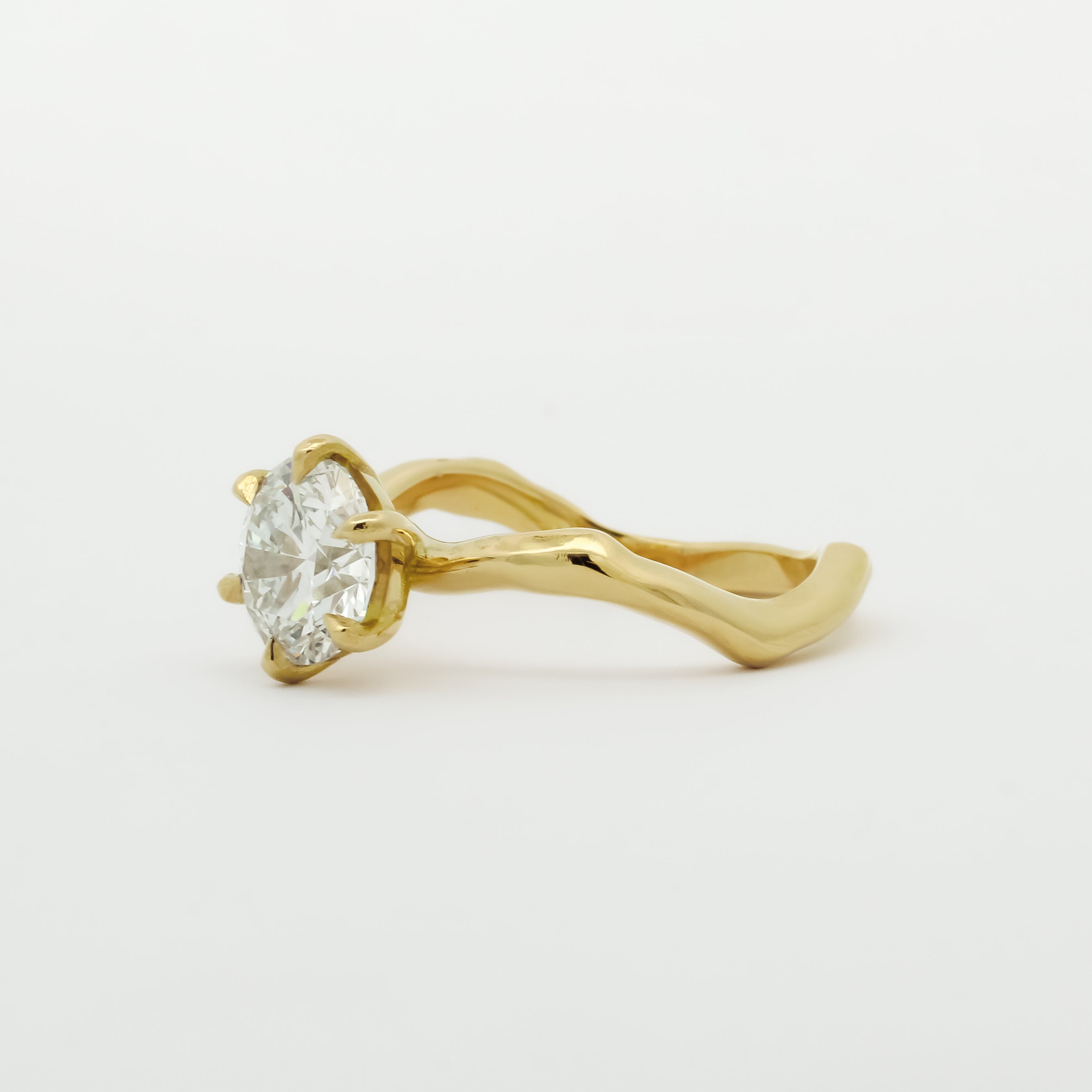 Gold ring with a diamond on a white background