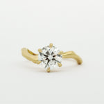 Gold ring with a diamond on a white background