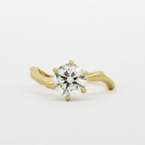 Gold ring with a diamond on a white background