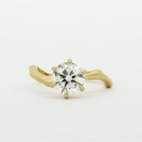 Gold ring with a diamond on a white background
