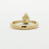 back view of a pear green sapphire engagement ring with textured band