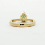 back view of a pear green sapphire engagement ring with textured band