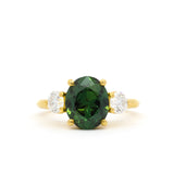 large green sapphire engagement ring with large green centre stone and round 4mm lab diamonds on a white background