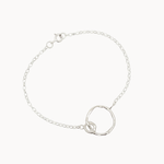 Silver bracelet with a unique ring design on a white background