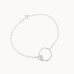 Silver bracelet with a unique ring design on a white background
