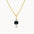 close up of a dainty gold necklacre with a dark blue rectangular sapphire flanked by a round and pear diamond against a white background