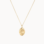 Gold capricorn necklace with a pendant on a white background