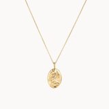Gold capricorn necklace with a pendant on a white background