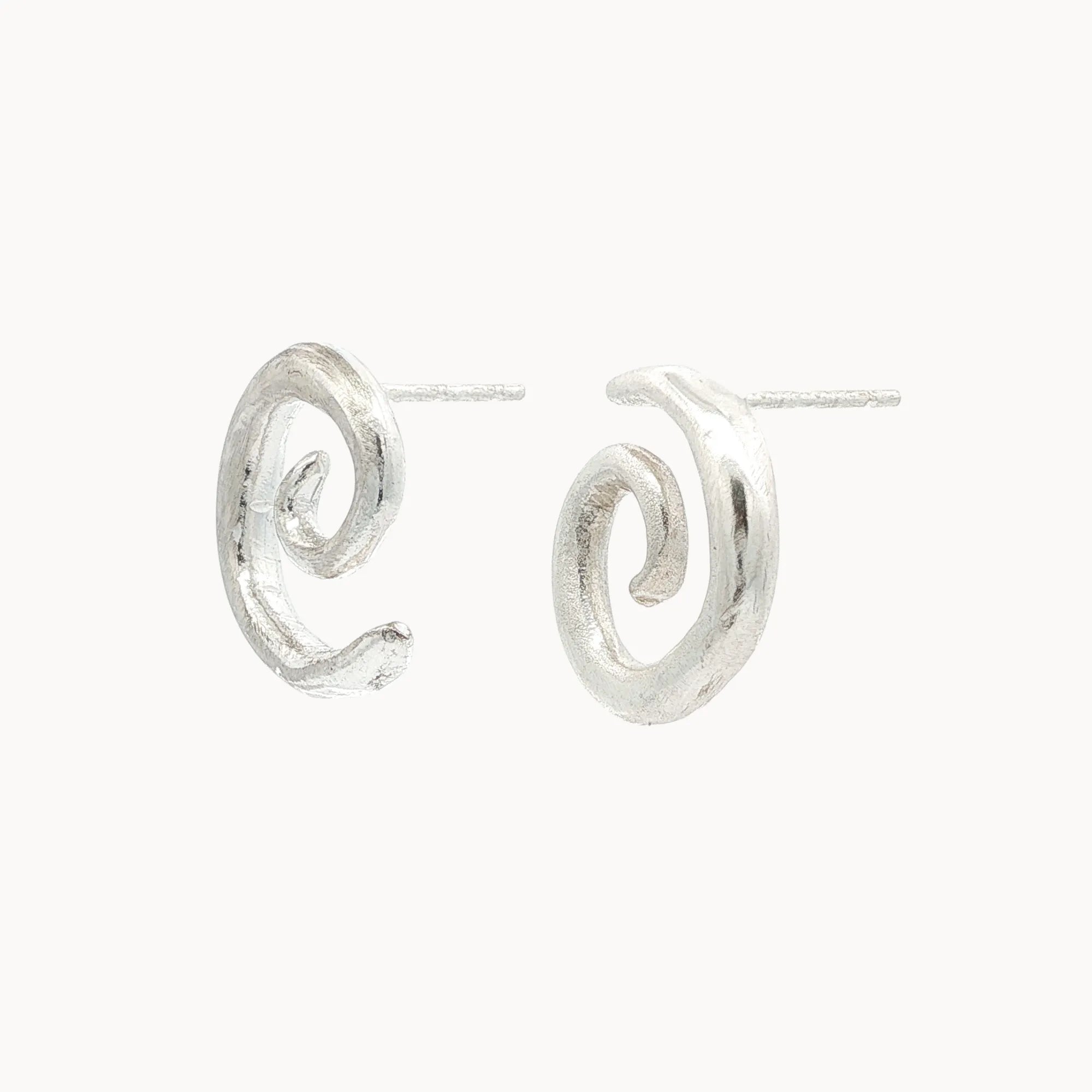 Silver spiral earrings on a white background