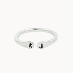 silver open ring with 'k' and 'j' stamped initials on a white background