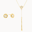 Gold jewelry set with round diamond stud earrings and a y-shaped diamond molten necklace on a white background