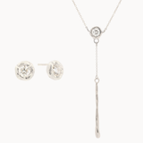 white gold jewelry set with diamond stud earrings and a y-shaped diamond molten necklace on a white background