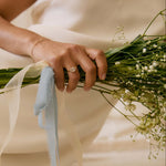 Person holding a bouquet of flowers with a soft focus background