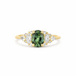 13 stone engagement ring with one oval sapphire and different shaped diamonds on a white background
