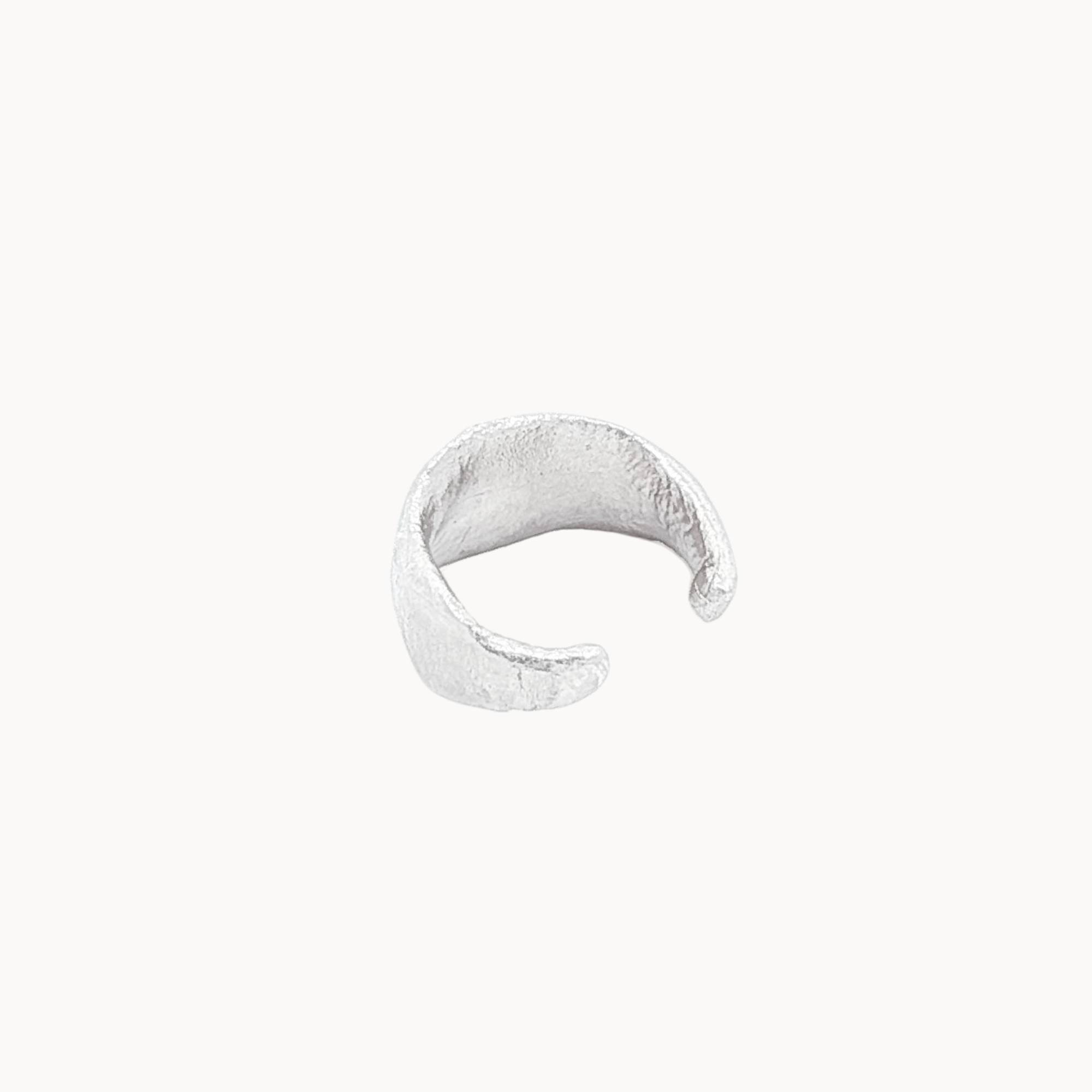 Silver ear cuff back view on a white background