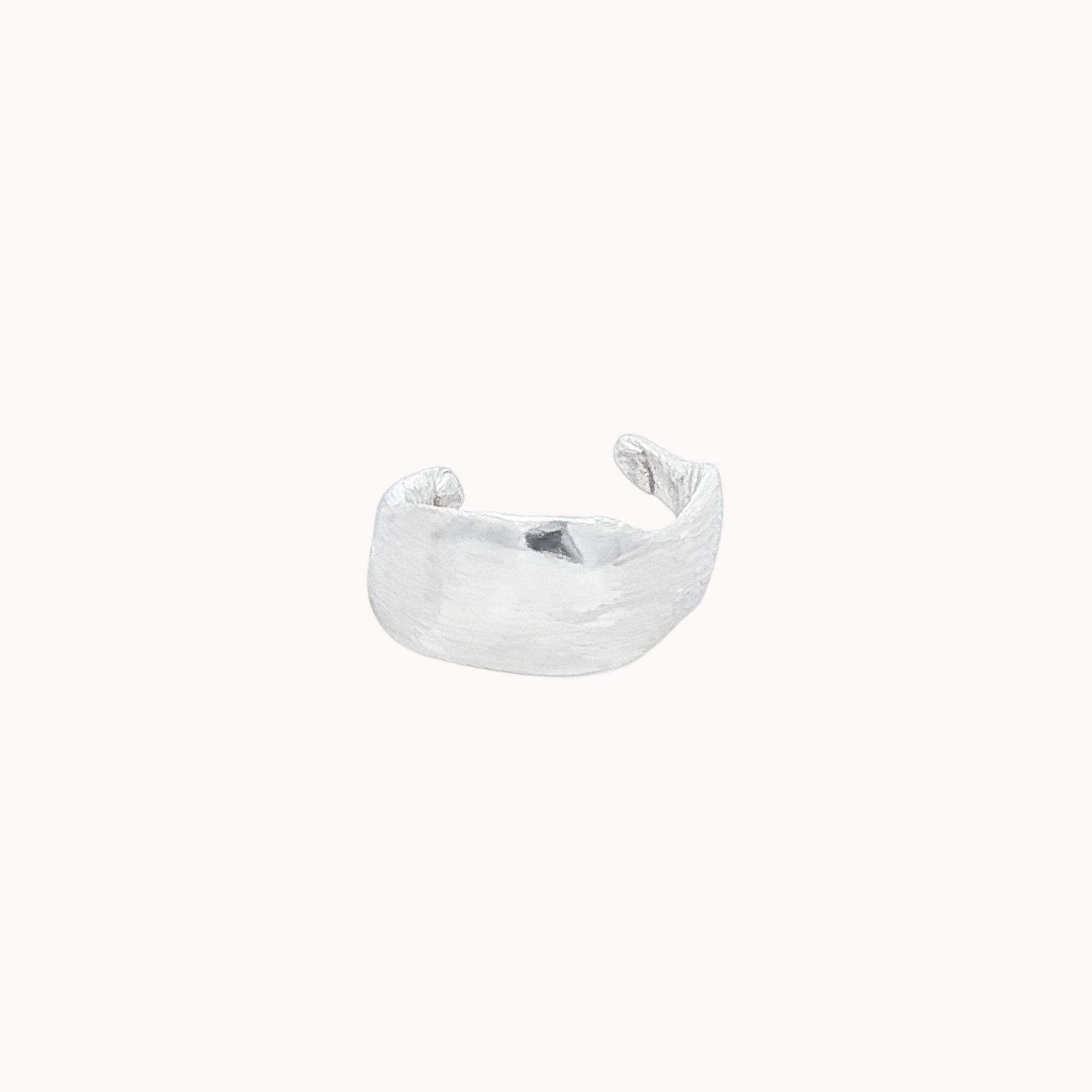 Silver leaf shaped ear cuff on a white background