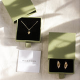 green gift boxes with gold acorn necklace and leaf earring with Wild Fawn care card