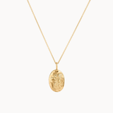 gold gemini necklace with oval pendant on a white background