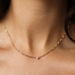 brunette model wearing a chain necklace with round diamond pendant