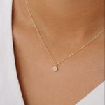 close up of gold dot necklace being worn