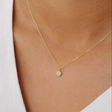 close up of gold dot necklace being worn