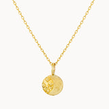 Gold necklace with a round moonlight pendant on a white background