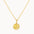 Gold necklace with a round moonlight pendant on a white background