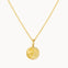 Gold necklace with a round moonlight pendant on a white background