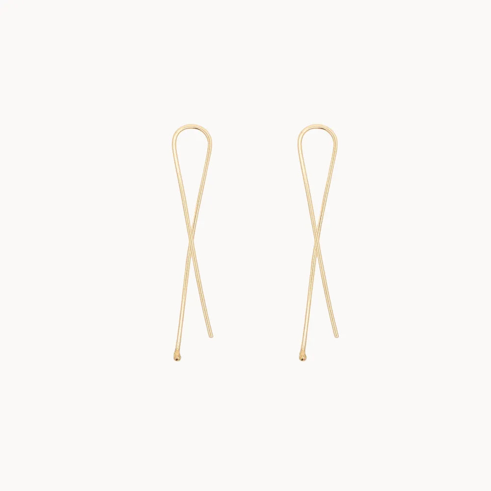 twisted gold earrings on white background