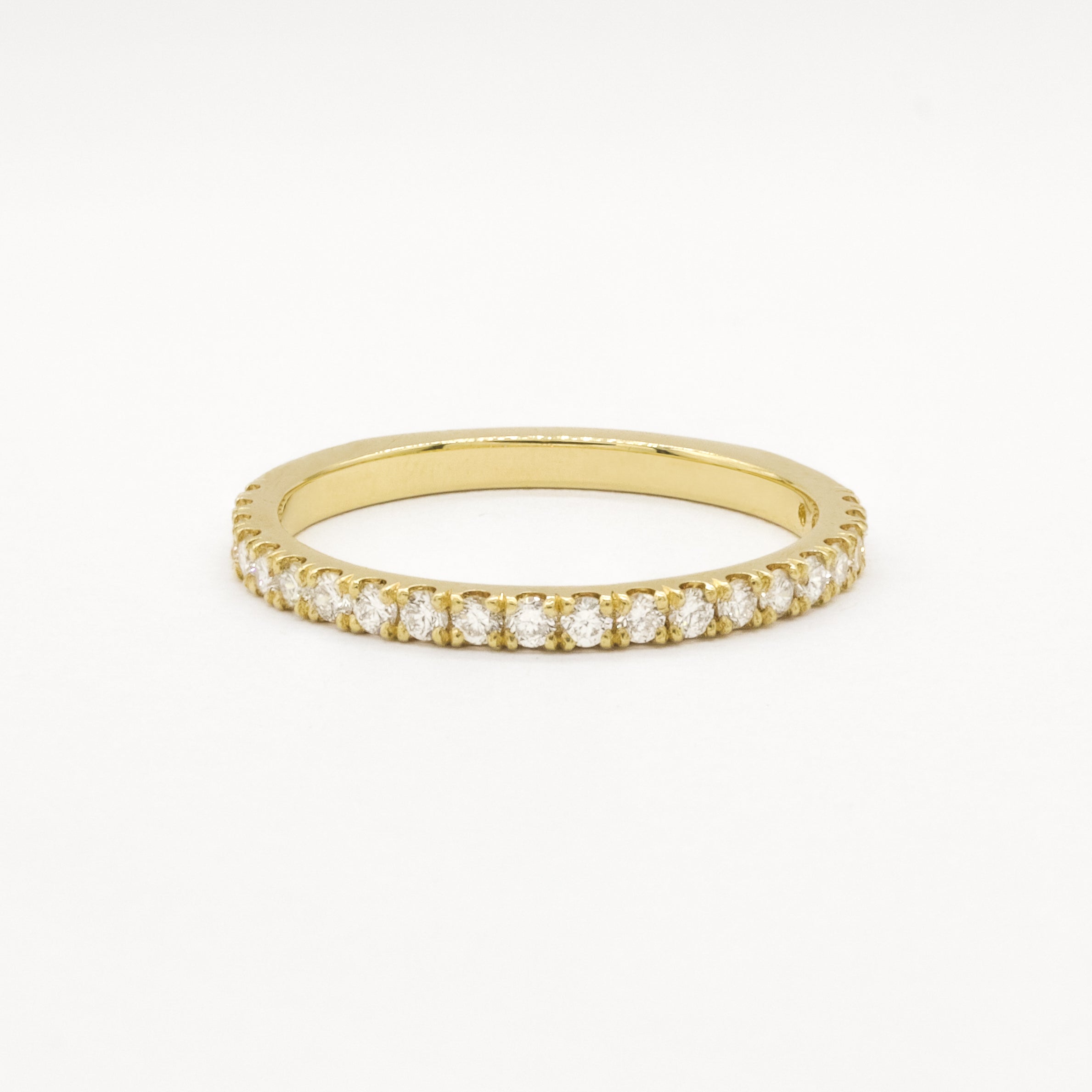 Gold eternity wedding ring in 1.6mm width with small diamonds on a white background
