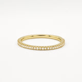 Gold eternity wedding ring with 1mm small diamonds on a white background