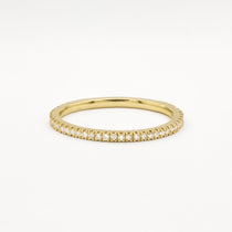 Gold eternity wedding ring with 1mm small diamonds on a white background