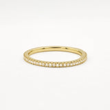 Gold eternity wedding ring with 1mm small diamonds on a white background