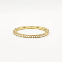 Gold eternity wedding ring with 1mm small diamonds on a white background