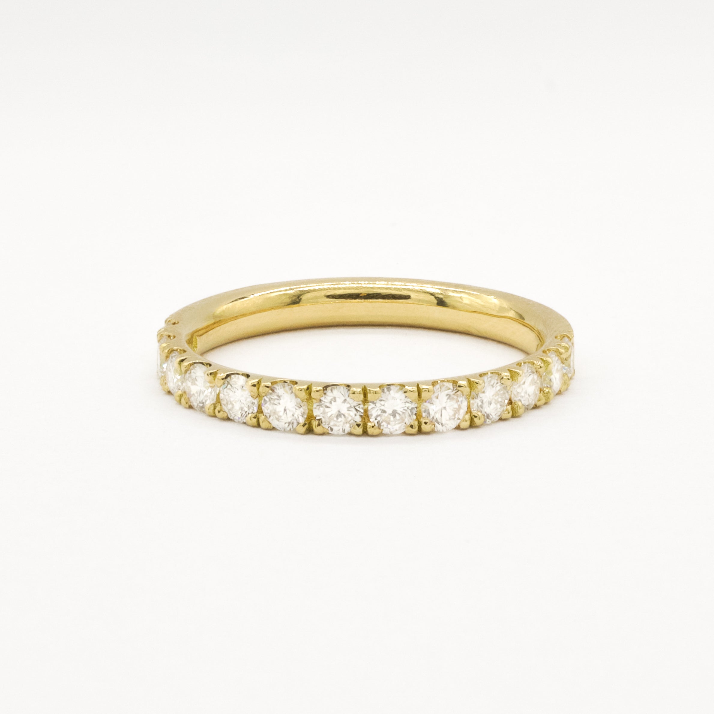 Yellow gold eternity ring with 2.3mm diamonds on a white background