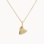 Gold heart-shaped pendant on a chain against a white background